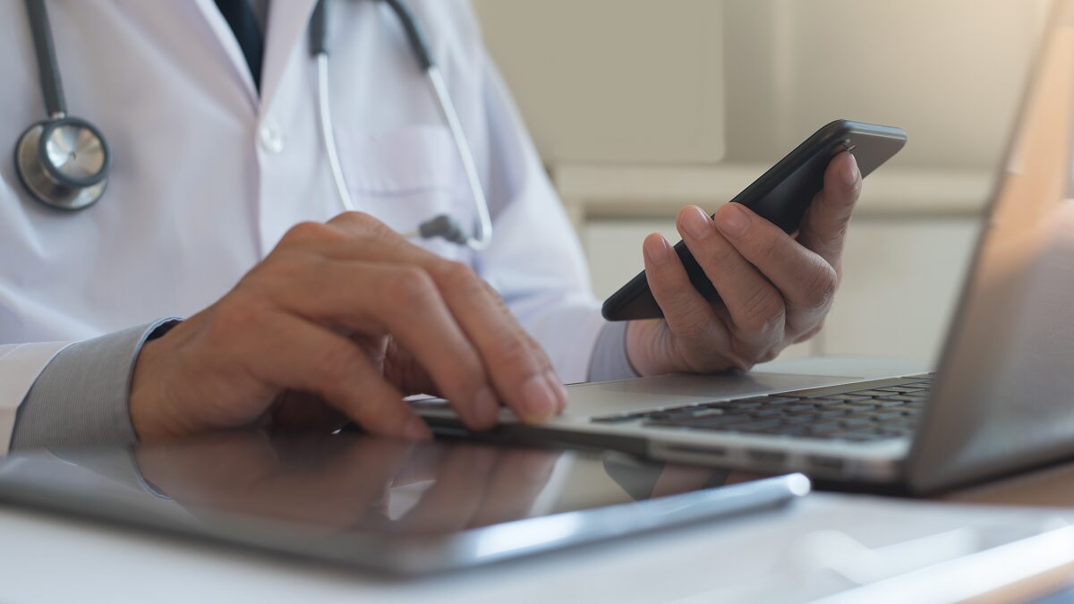 Physician conducting a telehealth video consultation on a laptop